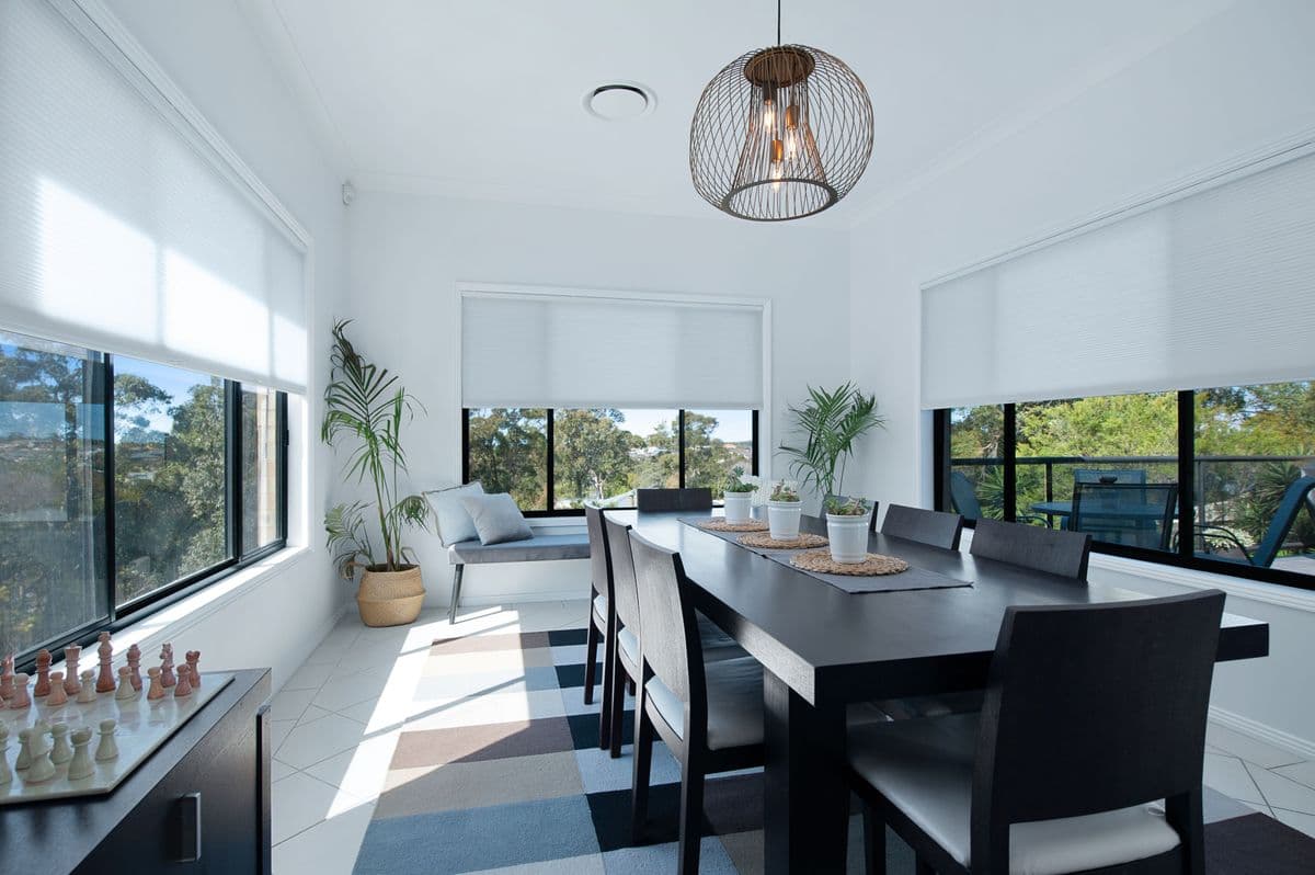 Designer roller shades in contemporary bedroom