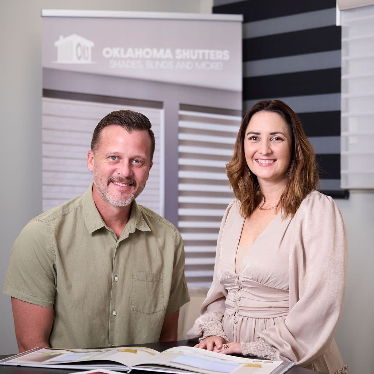 Satisfied homeowner couple standing in beautiful living room with custom white plantation shutters